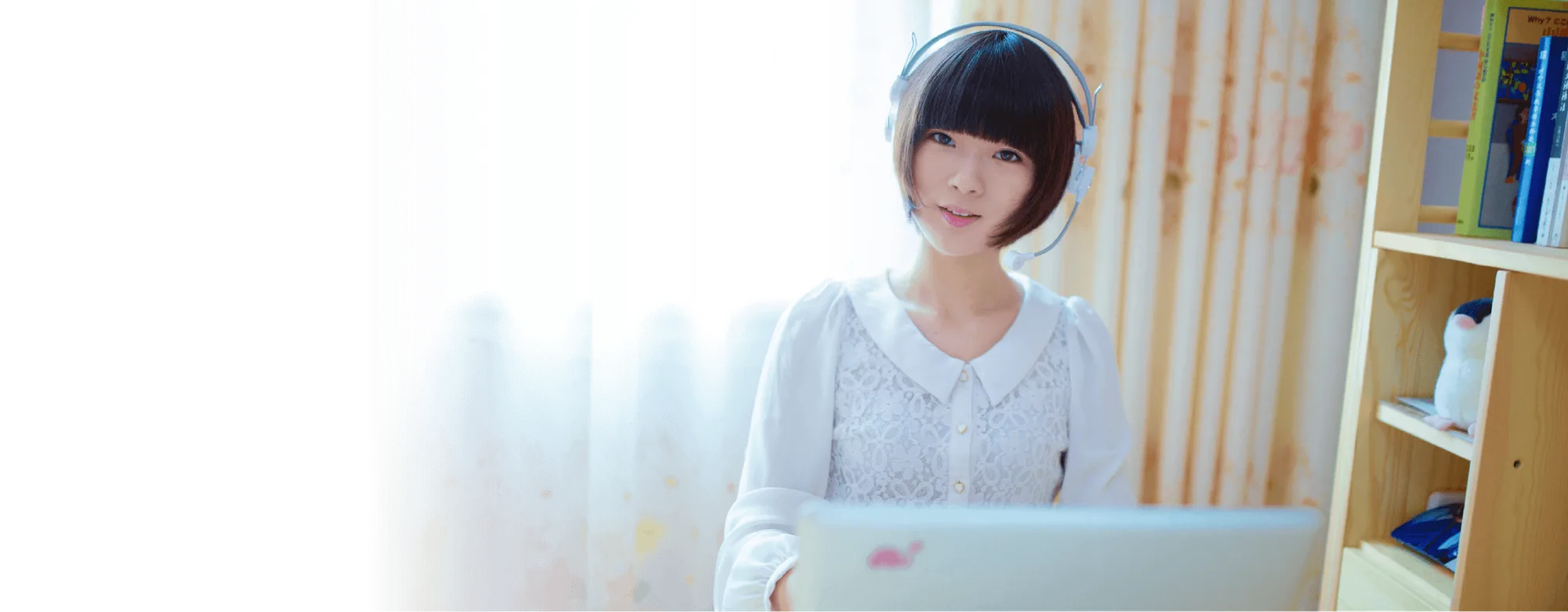 A student taking an online Chinese lesson with a headset