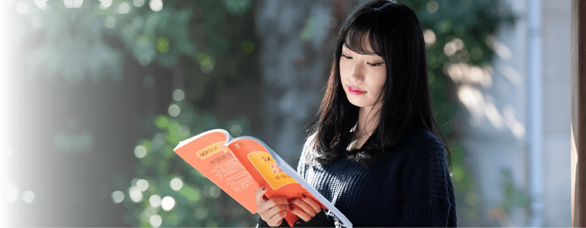 A student studying a Chinese textbook
