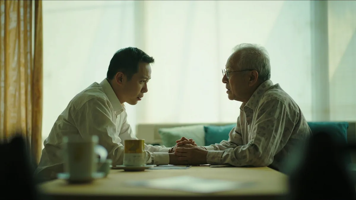 A young adult speaks candidly to an elder in a quiet room, illustrating “speaking the honest truth” in Chinese: 实话实说 (shí huà shí shuō)