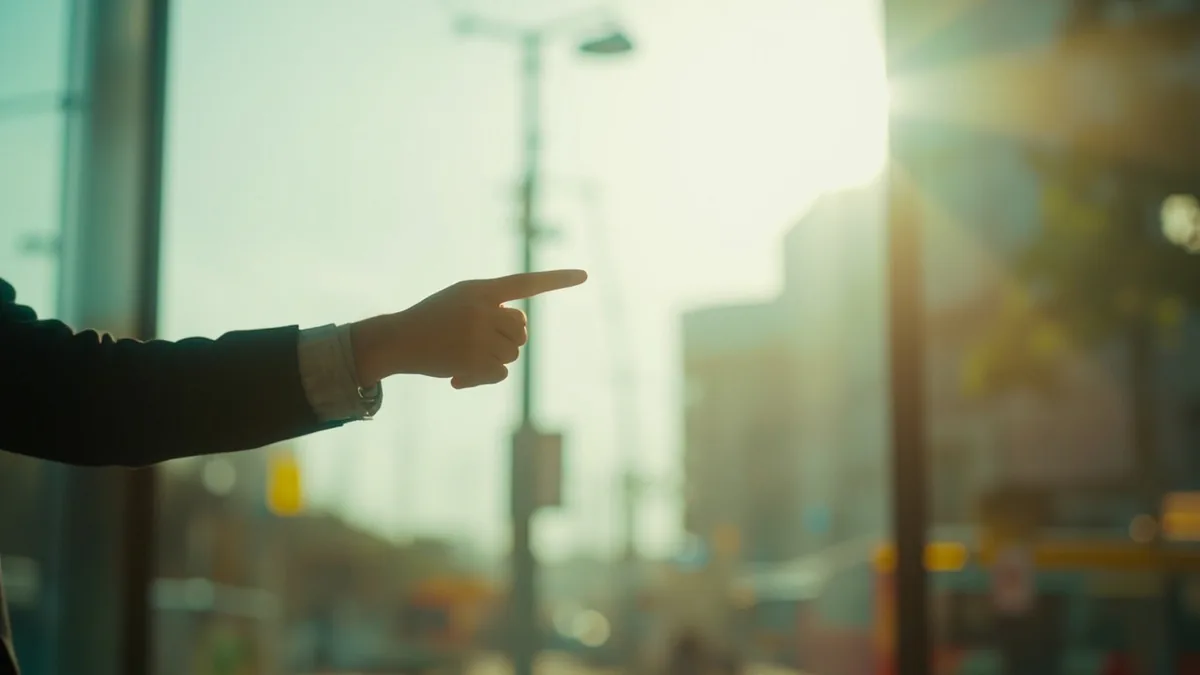 Adult's hand gestures towards a distant destination, expressing a clear intent to depart, illustrating “go” in Chinese: 去 (qù)