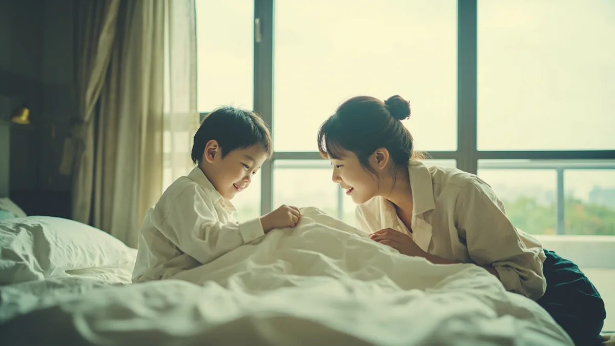 A parent gently tucks their child into bed at the end of the day, illustrating “good night, sweet dreams” in Chinese: 晚安，好梦 (wǎn'ān, hǎo mèng)
