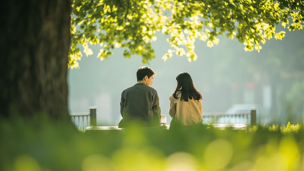 Two friends share a quiet, thoughtful moment in a peaceful park setting, illustrating “peace and love” in Chinese: 和平与爱 (hé píng yǔ ài)