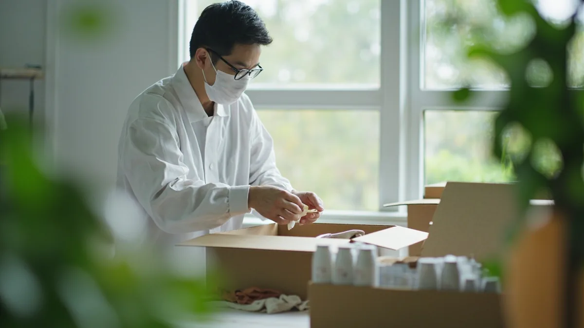 A supplier prepares small product samples for a client, illustrating “send samples first” in Chinese: 先发样品 (xiān fā yàngpin)